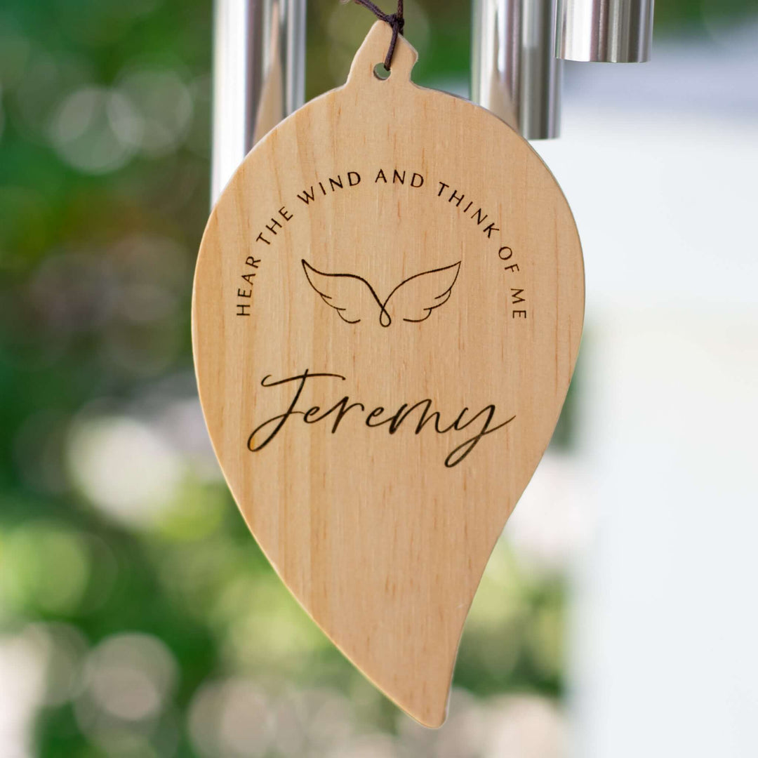 Hear the Wind and Think of Me Wind Chime wooden tag with engraved text and angel wings design for memorial gifting.