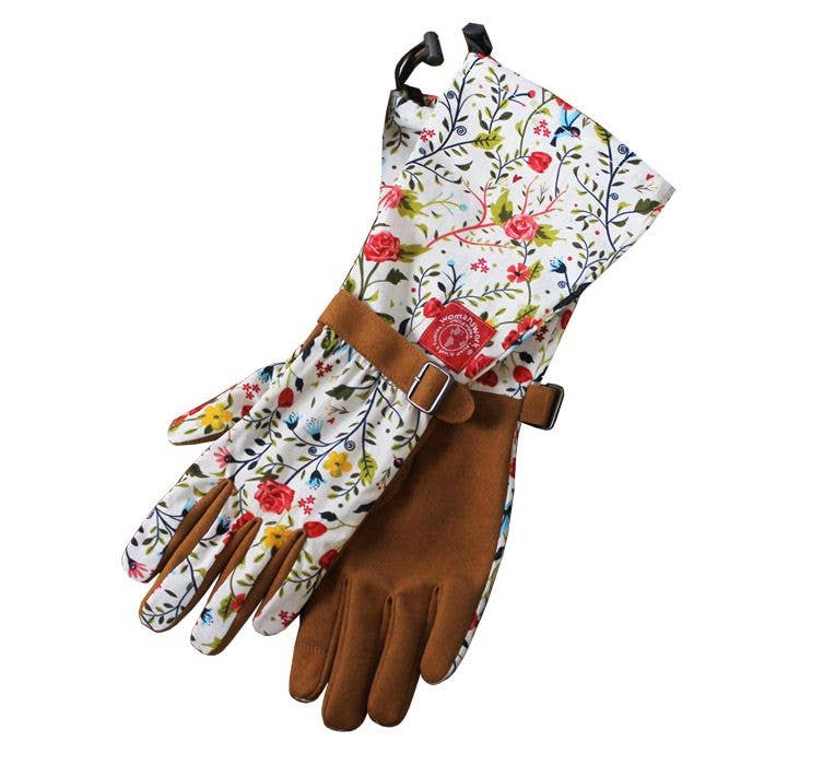 A close-up of floral garden gloves showing the interior side of the gloves laying flat on a white background