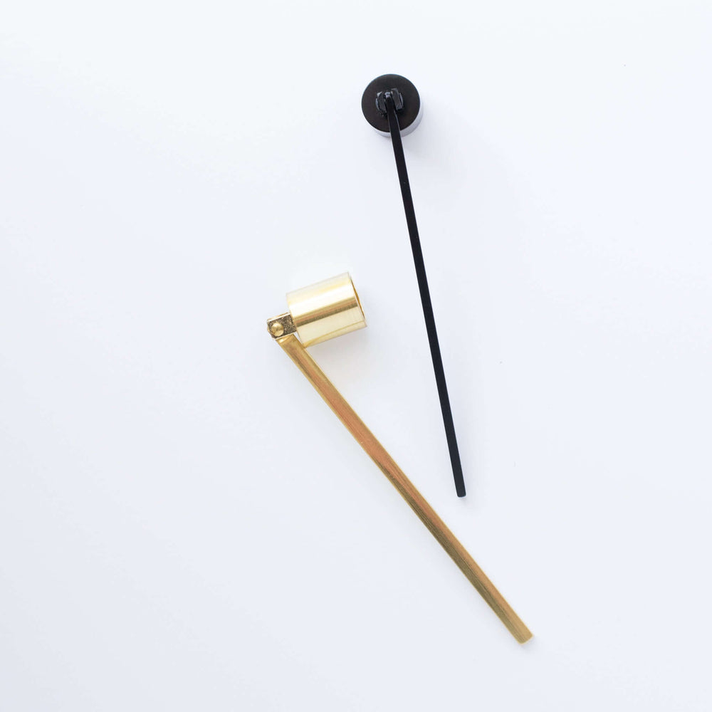 Candle Snuffer in brushed gold with a cylindrical cup, paired with a matte black slender handle on a white background.