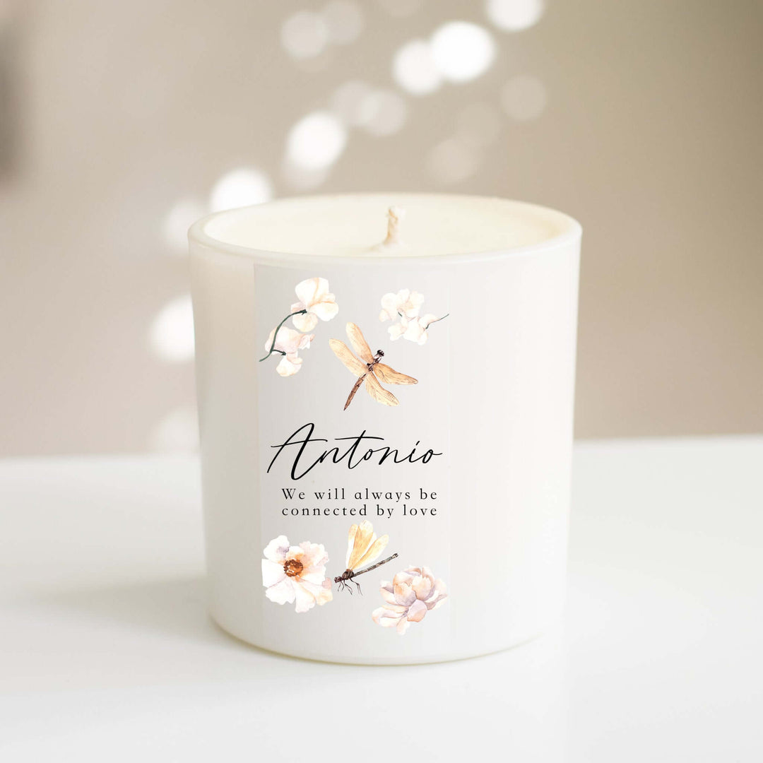 Custom Butterfly or Dragonfly Candle with personalized label, featuring a dragonfly and flowers, in a white glass container.