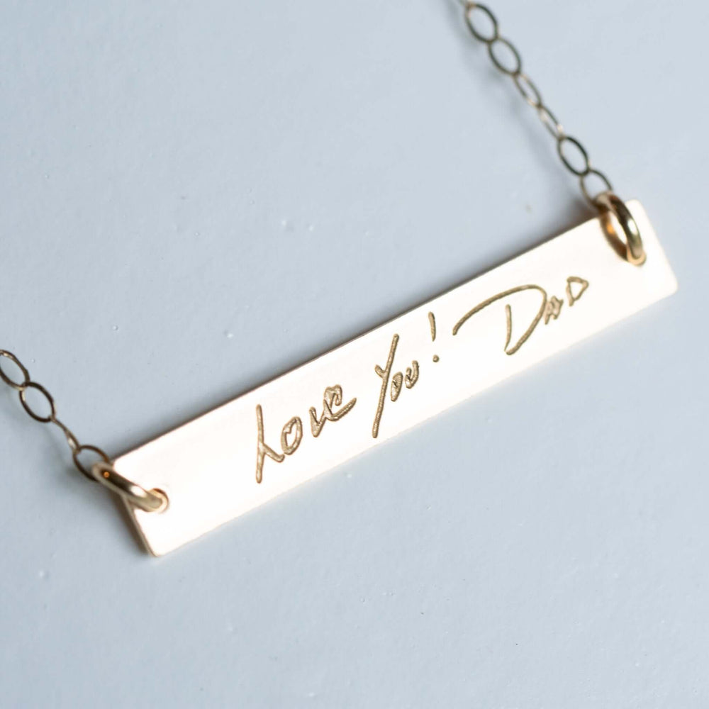 Custom Engraved Handwriting Necklace with a gold-colored charm engraved with "Love You! Dad" and attached to a delicate chain.