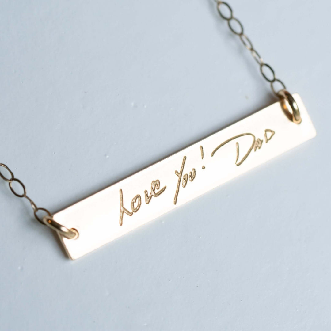 Custom Engraved Handwriting Necklace with a gold-colored charm engraved with "Love You! Dad" and attached to a delicate chain.