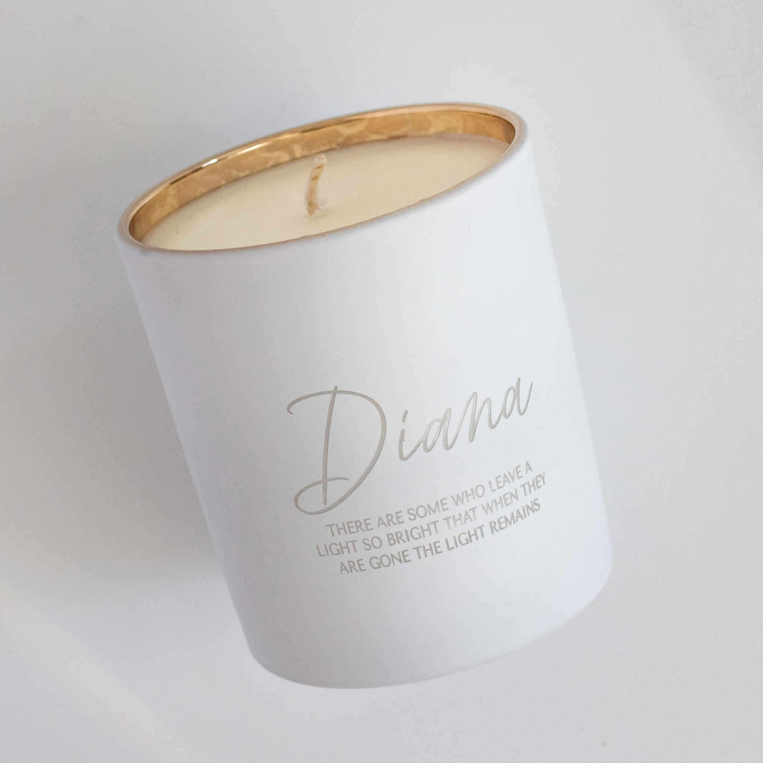 Their Light Remains Candle in white with gold rim, engraved with the name Diana and memorial quote.