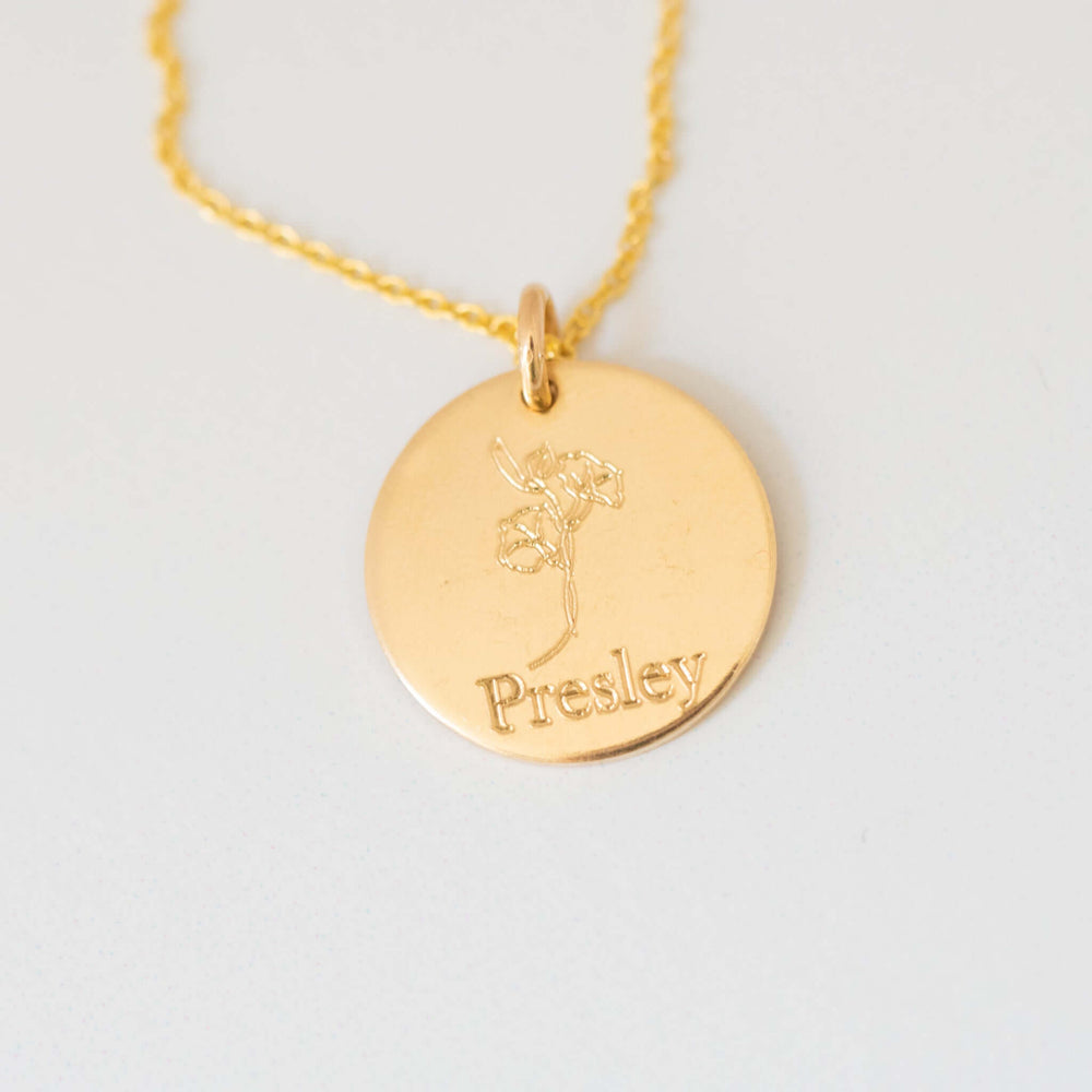 Gold filled birth flower necklace charm with engraving 'Presley' and floral design, attached to a delicate chain.