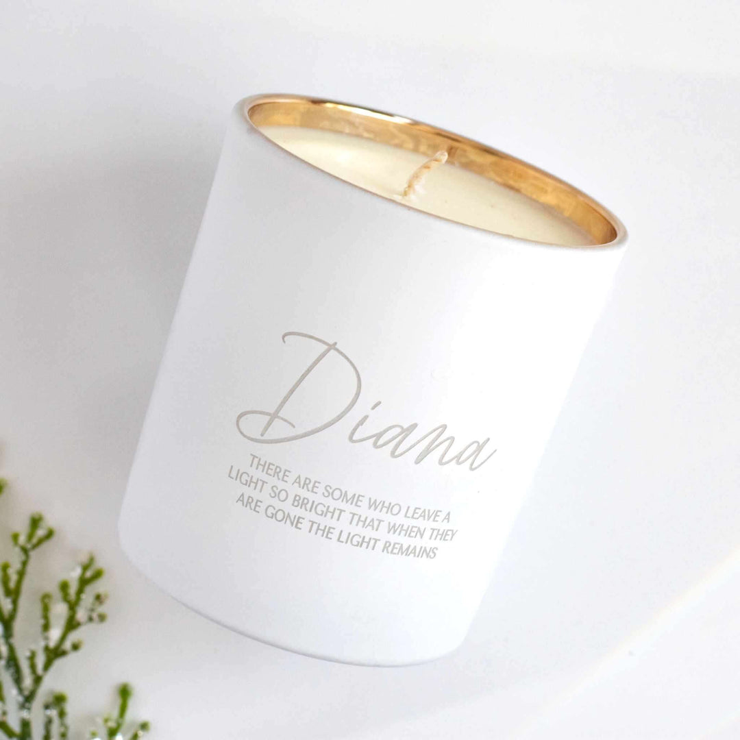 Their Light Remains Candle in white glass with gold rim, engraved name 'Diana' and memorial quote on side.